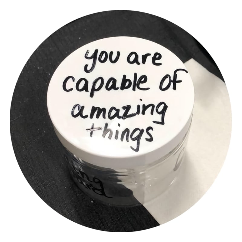 a scrub jar with the words "you are capable of amazing things" written on the lid.